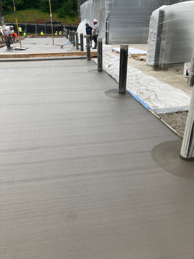 Concrete bollards in freshly poured concrete